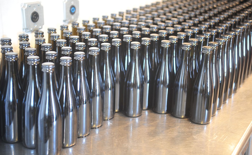 Bottles wait to be labeled at the Stoic Cider orchard and bottling facility Tuesday, May 29 in Williamson Valley northwest of Prescott. (Les Stukenberg/Courier)