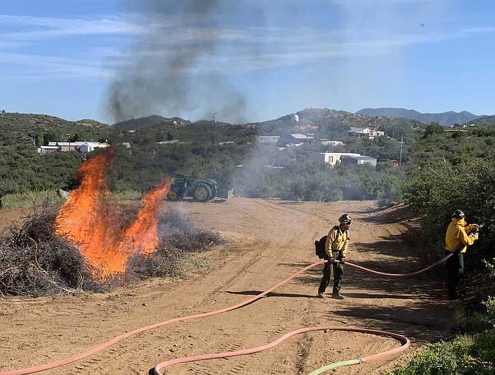 In this undated photo, members of the Southern Yavapai Fire Department work on burning access fuel during a recent burning day. Due to “dry conditions and wind,” Southern Yavapai Fire and surrounding departments in the southern basin of Yavapai County have initiated Stage 1 fire restrictions for Skull Valley, Yarnell, Peeples Valley and Wilhoit areas effective Monday, June 17, 2019. (Southern Yavapai Fire/Courtesy)