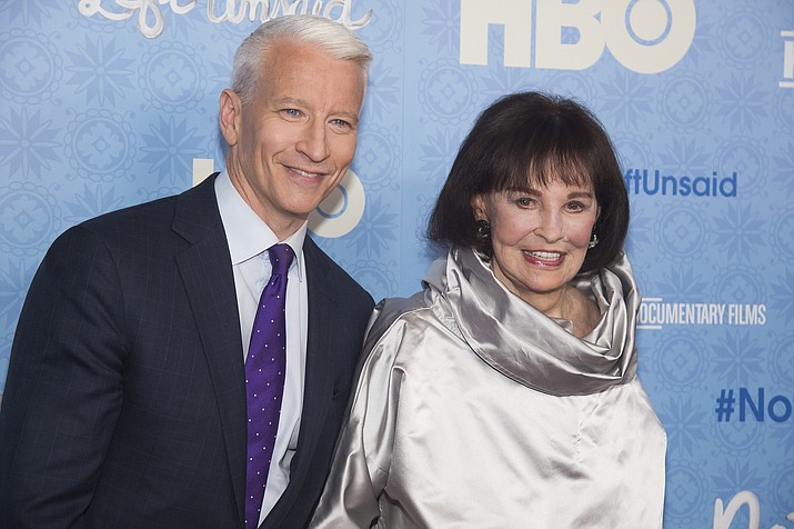 In this April 4, 2016 file photo, CNN anchor Anderson Cooper and Gloria Vanderbilt attend the premiere of "Nothing Left Unsaid" at the Time Warner Center in New York. Vanderbilt, the "poor little rich girl" heiress at the center of a scandalous custody battle of the 1930s and the designer jeans queen of the 1970s and '80s, died on Monday, June 17, 2019, at 95, according to her son, Cooper. (Charles Sykes/Invision/AP, File)