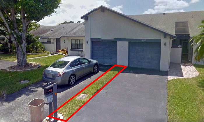 Florida resident Kerville Holness thought he snagged a Florida villa for $9,100 in a Broward online auction, but the purchase turned put to be a 1-foot-by-100-foot strip of grass that runs between two villas on Northwest 100th Way in Spring Lake, pictured here outlined in red. (Google Maps)