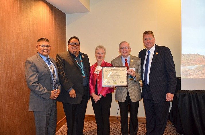 Speaker Seth Damon presents American Public Power Association leadership an appreciation plaque with Paulson Chaco, left, and NTUA CEO Walter Haase, right, after thanking the utilities that participated in the Light Up Navajo initiative at the APPA Conference in Austin, Texas. (Office of the Speaker)