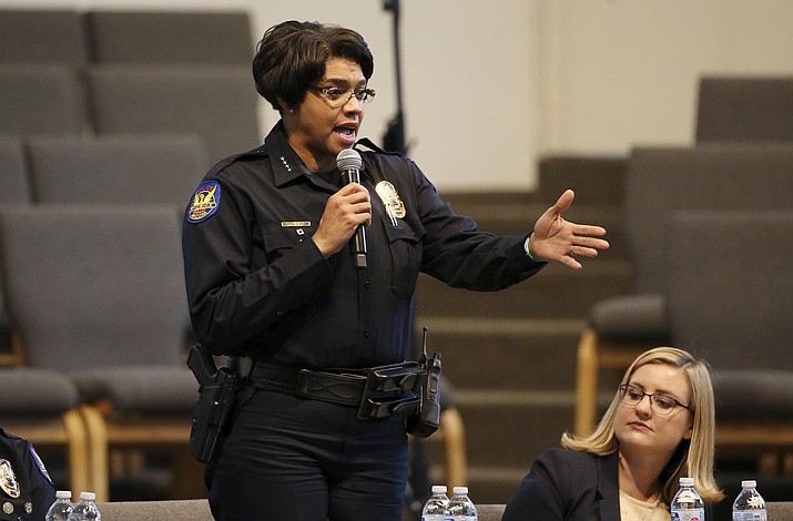 Phoenix Police Chief Jeri Williams speaks at a community meeting, as Phoenix Mayor Kate Gallego, seated, listens, Tuesday, June 18, 2019, in Phoenix. The community meeting stems from reaction to a videotaped encounter that surfaced recently of Dravon Ames and his pregnant fiancee, Iesha Harper, having had guns aimed at them by Phoenix police during a response to a shoplifting report, as well as the issue of recent police-involved shootings in the community. (Ross D. Franklin/AP)