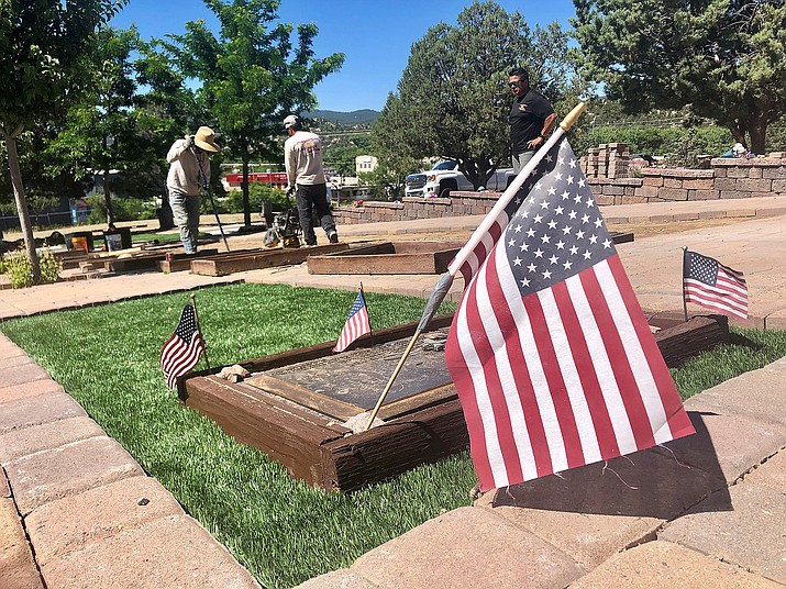 Angel Sun Enterprises Inc. crew members Hugo Sandoval, left, and Edwin Manuel, center, work to refurbish the Granite Mountain Hotshots’ memorial burial site at the Arizona Pioneers’ Home Cemetery this week, as company owner JP Vicente, right, looks on. (Cindy Barks/Courier)