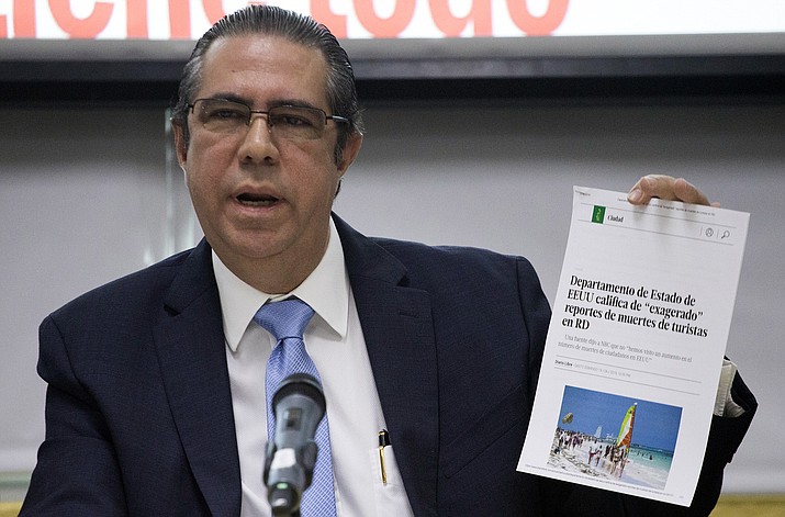 The Minister of Tourism of the Dominican Republic Francisco Javier Garc a, holds a copy of an online article in a local paper saying the U.S. State Department considers recent reports on tourists' deaths to be exaggerated, at the Ministry of Tourism office in Santo Domingo, Dominican Republic, Friday, June 21, 2019. (Tatiana Fernandez/AP)