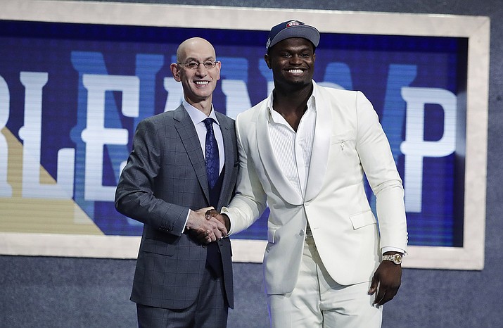 Duke’s Zion Williamson, right, poses for photographs with NBA Commissioner Adam Silver after being selected by the New Orleans Pelicans as the first pick during the NBA draft Thursday, June 20, 2019, in New York. (Julio Cortez/AP)