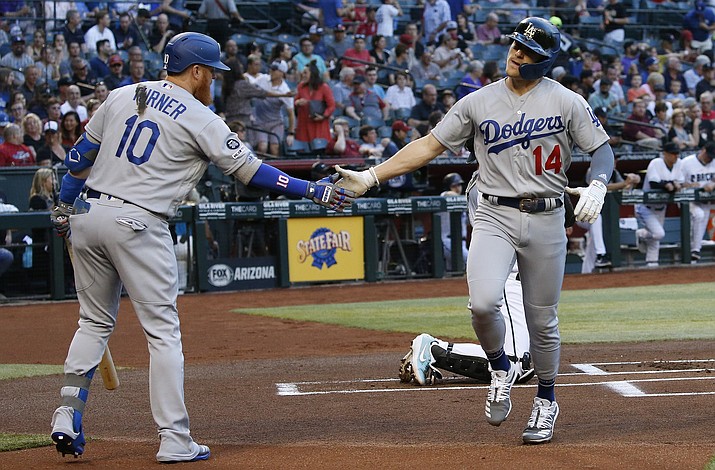 Los Angeles Dodgers' Enrique Hernandez (14) celebrates his home run against the Arizona Diamondbacks with Dodgers' Justin Turner (10) during the first inning of a baseball game, Tuesday, June 25, 2019, in Phoenix. (Ross D. Franklin/AP)