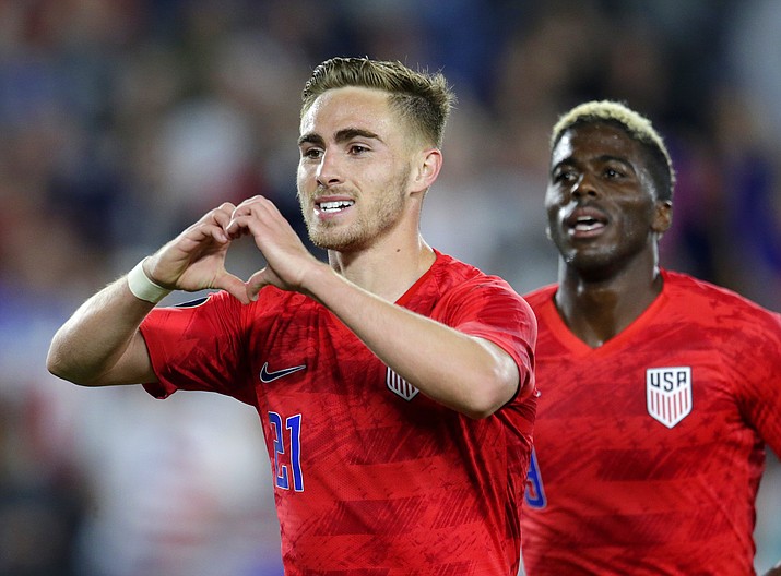 United States' Tyler Boyd, left, celebrates his goal against Guyana with fans as teammate Gyasi Zardes follows during the second half of a CONCACAF Gold Cup soccer match Tuesday, June 18, 2019, in St. Paul, Minn. (Andy Clayton-King/AP)