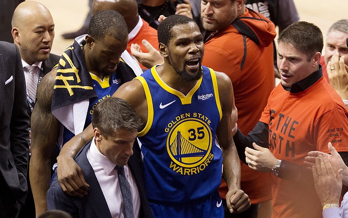 In this June 10, 2019, file photo, Golden State Warriors forward Kevin Durant (35) reacts as he leaves the court after sustaining an injury during first-half basketball action against the Toronto Raptors in Game 5 of the NBA Finals in Toronto. Durant is headed to the Brooklyn Nets, leaving the Warriors after three seasons. His decision was announced Sunday, June 30, 2019, at the start of the NBA free agency period on the Instagram page for The Boardroom, an online series looking at sports business produced by Durant and business partner Rich Kleiman. (Chris Young/The Canadian Press via AP, file)