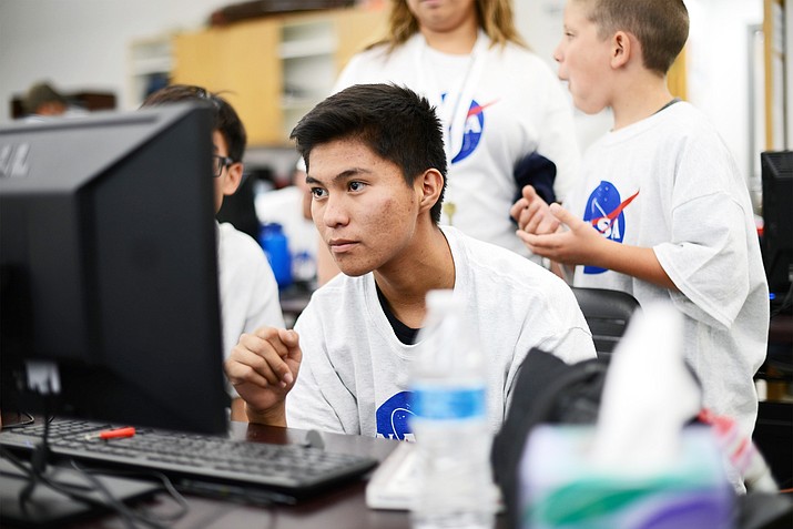A student at the NASA Robotics camp carefully looks over his project during the 2019 camp held at Navajo Technical University's main campus. (Photo courtesy of Navajo Technical University)