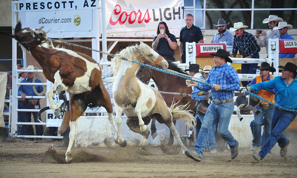Wild Horse Race action during the first performance of the Prescott Frontier Days Rodeo Monday July 1, 2019. (Les Stukenberg/Courier)