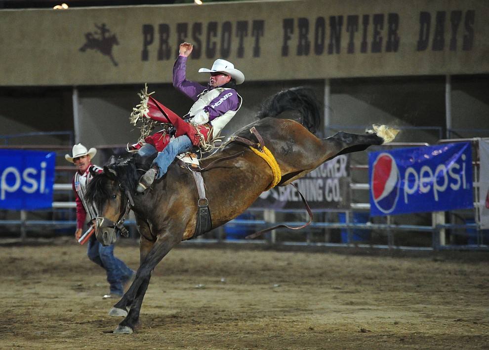 Shane O'Connell scores 81.5 on Frisky Chicken in the bareback riding during the first performance of the Prescott Frontier Days Rodeo Monday July 1, 2019. (Les Stukenberg/Courier)