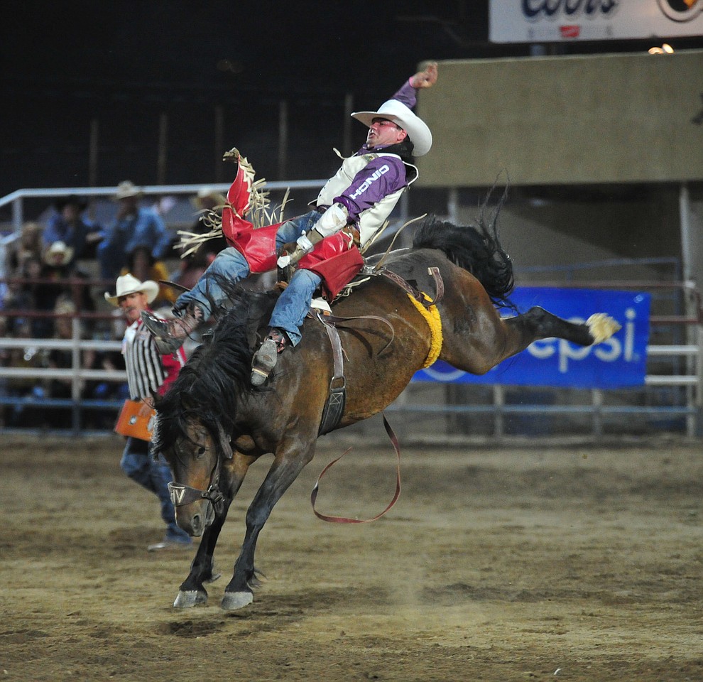 Shane O'Connell scores 81.5 on Frisky Chicken in the bareback riding during the first performance of the Prescott Frontier Days Rodeo Monday July 1, 2019. (Les Stukenberg/Courier)