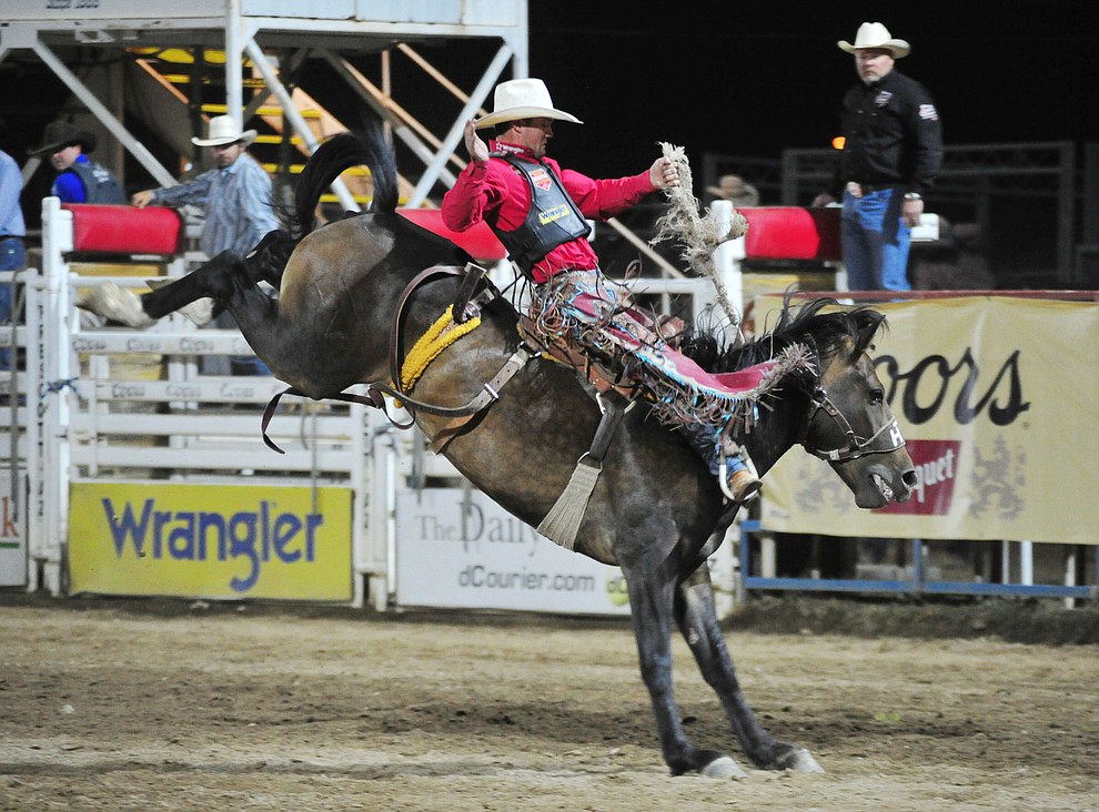 CoBurn Bradshaw scores 84 on Joker for the lead in the saddle bronc riding during the first performance of the Prescott Frontier Days Rodeo Monday July 1, 2019. (Les Stukenberg/Courier)