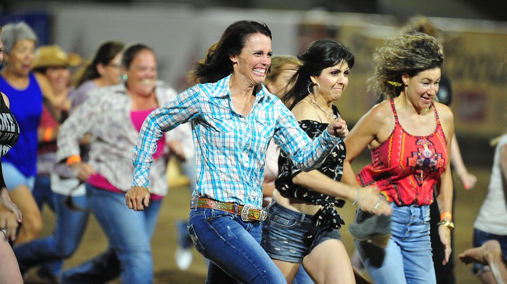 Ladies chased their boot for a chance at $250 during the first performance of the Prescott Frontier Days Rodeo Monday July 1, 2019. (Les Stukenberg/Courier)