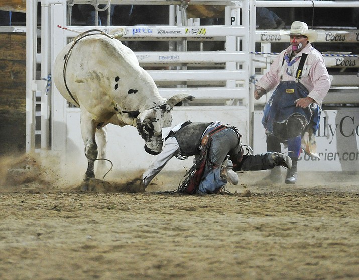 Chase Hamlin gets the hard end of Floating Fury in the bull riding during the second performance of the Prescott Frontier Days Rodeo Tuesday July 2, 2019.  (Les Stukenberg/Courier)
