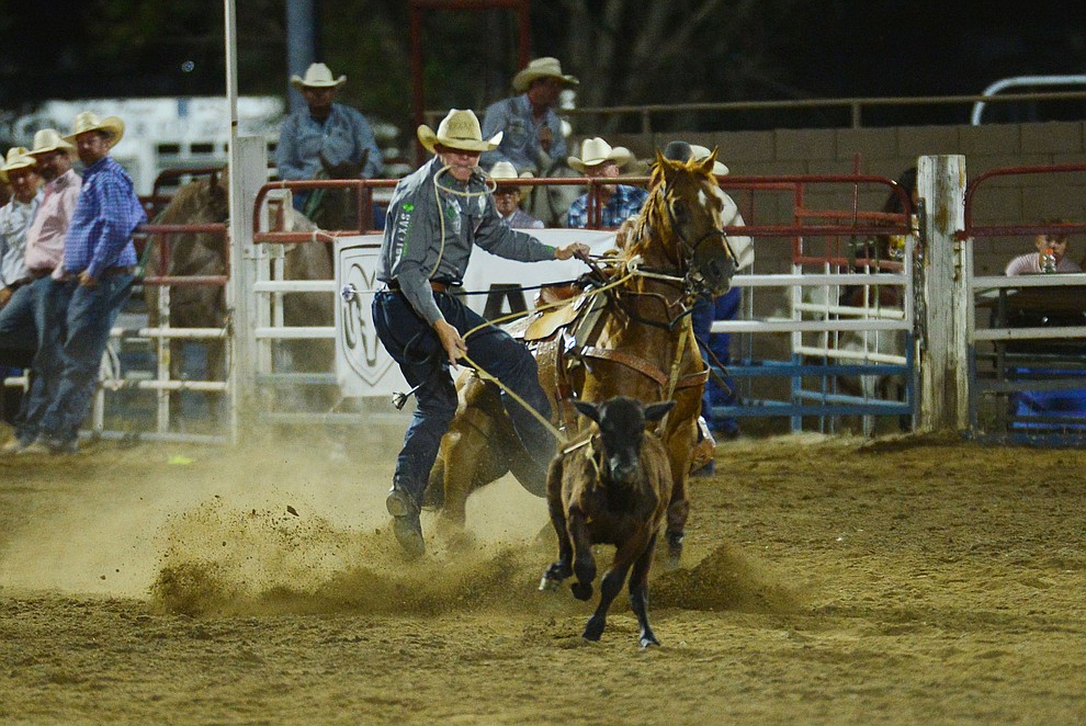 Marty Yates makes an 11.7 second run in the tie down roping during the third performance of the Prescott Frontier Days Rodeo Wednesday July 3, 2019. (Les Stukenberg/Courier)