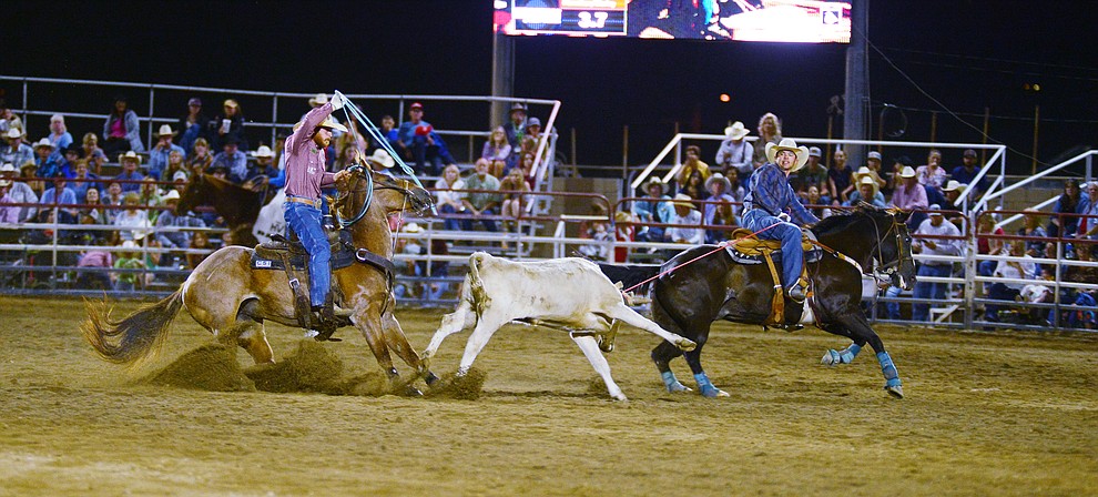 Tyler Worley and Jeff Flenniken make a 6.4 second run in the team roping during the third performance of the Prescott Frontier Days Rodeo Wednesday July 3, 2019. (Les Stukenberg/Courier)