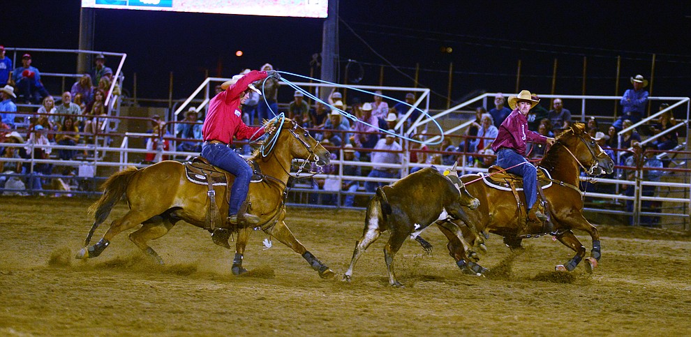 Buddy Hawkins and Tate Kirchenschlager make a 7.3 second run in the team roping during the third performance of the Prescott Frontier Days Rodeo Wednesday July 3, 2019. (Les Stukenberg/Courier)