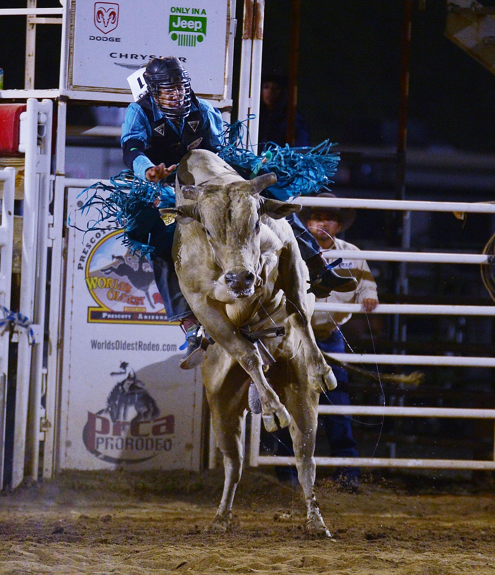 Wyatt Nez on Crazy Nights in the bull riding during the third performance of the Prescott Frontier Days Rodeo Wednesday July 3, 2019. (Les Stukenberg/Courier)