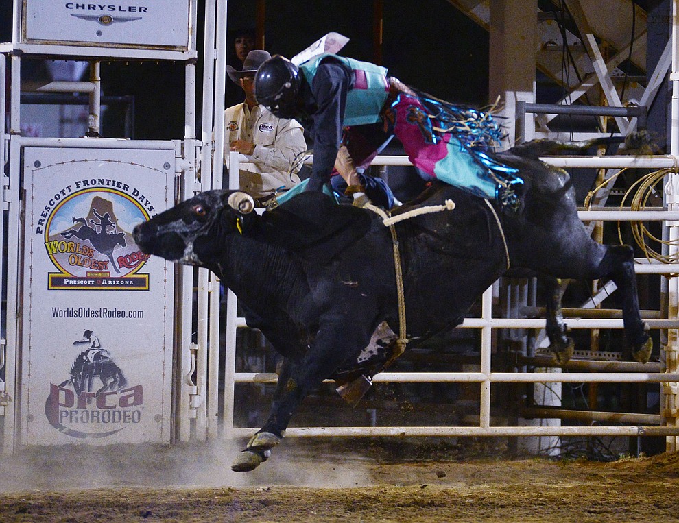 Paul Carrales gets air from Rustlers Roost in the bull riding during the third performance of the Prescott Frontier Days Rodeo Wednesday July 3, 2019. (Les Stukenberg/Courier)