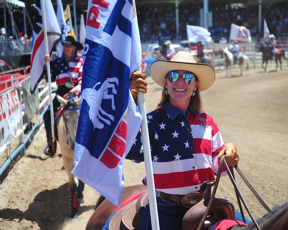 It was a star spangled grand entry during the fourth performance of the Prescott Frontier Days Rodeo Thursday July 4, 2019. (Les Stukenberg/Courier)