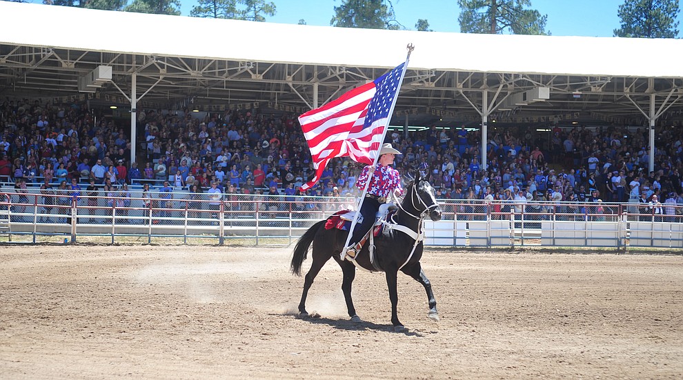 It was a star spangled grand entry during the fourth performance of the Prescott Frontier Days Rodeo Thursday July 4, 2019. (Les Stukenberg/Courier)