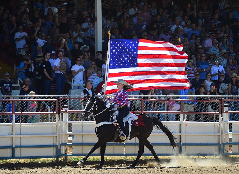 It was a star spangled grand entry during the fourth performance of the Prescott Frontier Days Rodeo Thursday July 4, 2019. (Les Stukenberg/Courier)