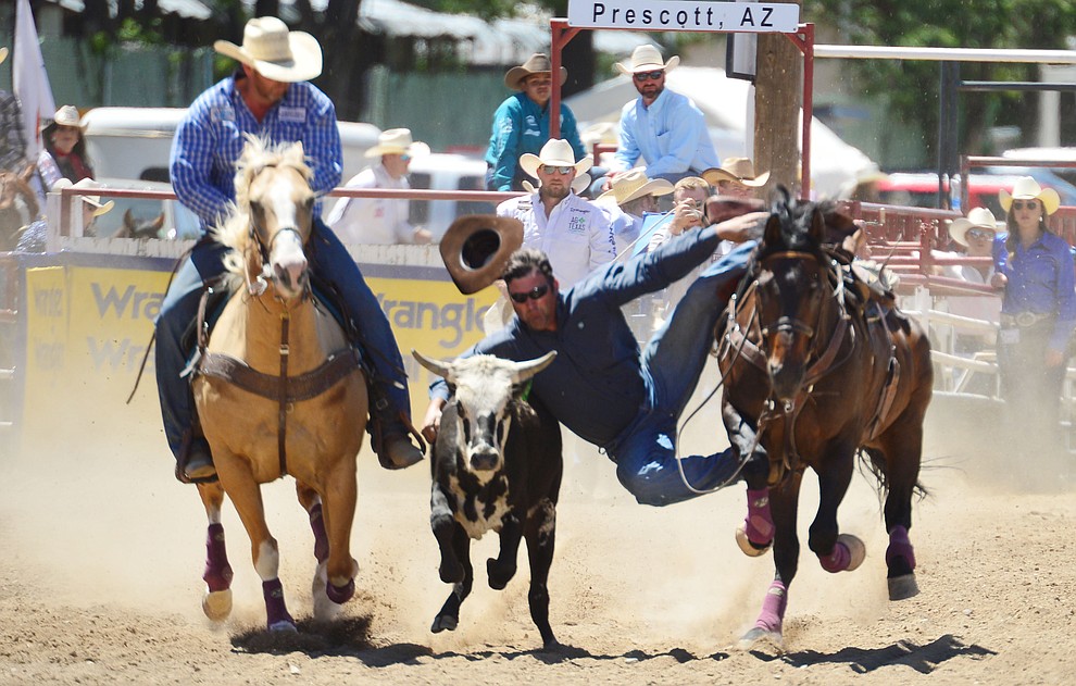 Matt Deskovick in the steer wrestling during the fourth performance of the Prescott Frontier Days Rodeo Thursday July 4, 2019. (Les Stukenberg/Courier)