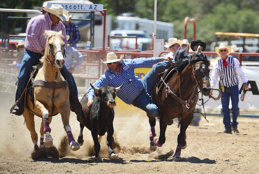 Dean McIntyre in the steer wrestling during the fourth performance of the Prescott Frontier Days Rodeo Thursday July 4, 2019. (Les Stukenberg/Courier)
