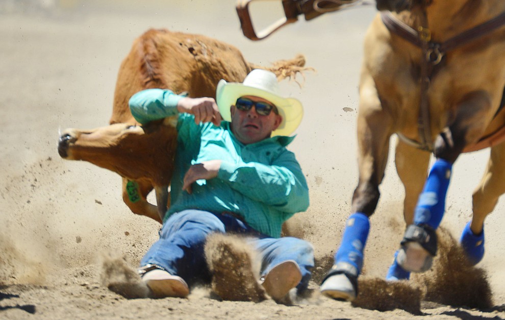 Clayton Tuchscherer in the steer wrestling during the fourth performance of the Prescott Frontier Days Rodeo Thursday July 4, 2019. (Les Stukenberg/Courier)