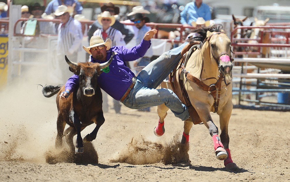 Stan Branco in the steer wrestling during the fourth performance of the Prescott Frontier Days Rodeo Thursday July 4, 2019. (Les Stukenberg/Courier)