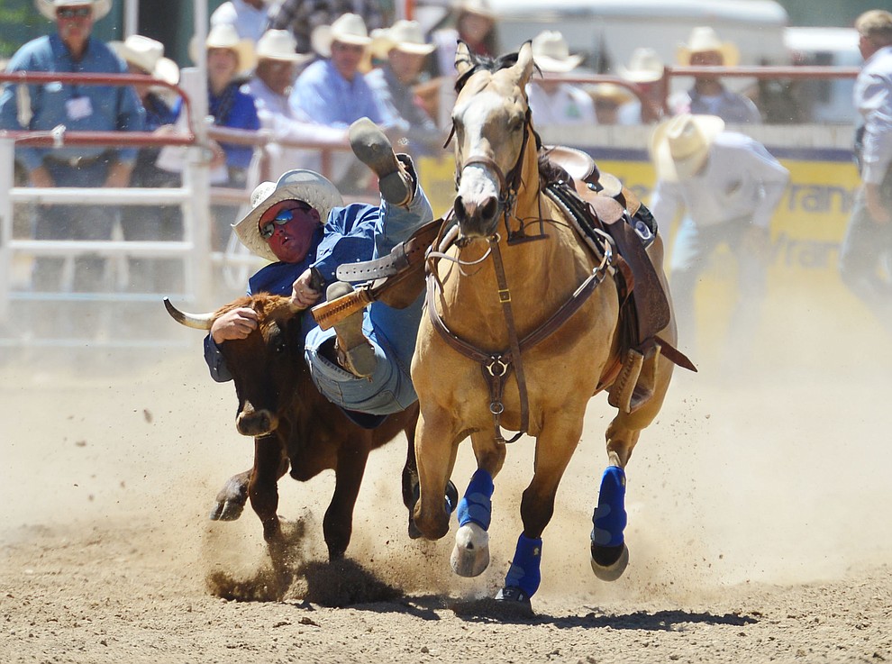 Monty Eakin in the steer wrestling during the fourth performance of the Prescott Frontier Days Rodeo Thursday July 4, 2019. (Les Stukenberg/Courier)