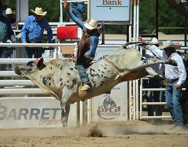 Daniel Keeping scores 86.5 on Last Cigarette in the bull riding during the fourth performance of the Prescott Frontier Days Rodeo Thursday July 4, 2019.  (Les Stukenberg/Courier)