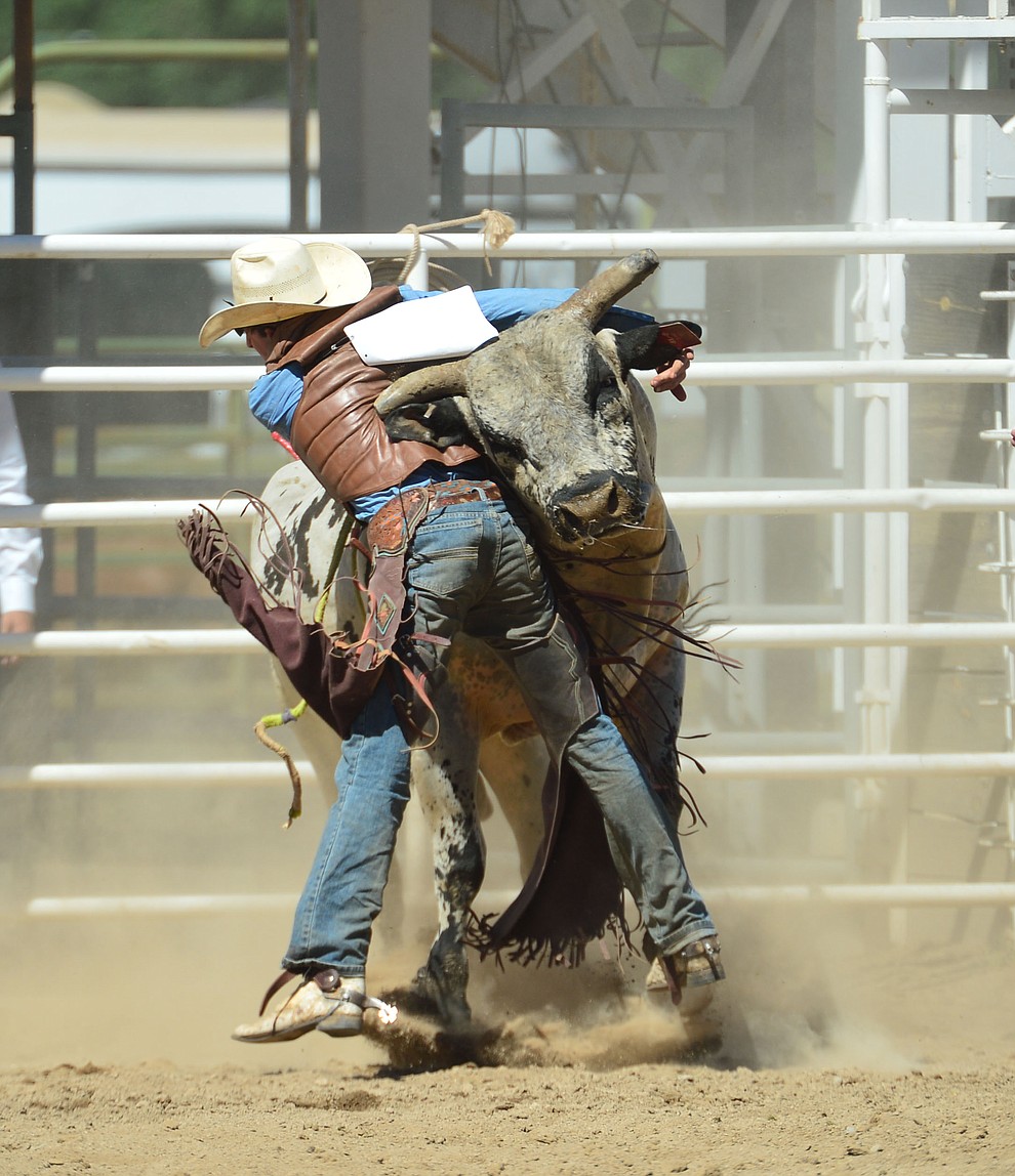 Daniel Keeping gets a hornful from Last Cigarette in the bull riding during the fourth performance of the Prescott Frontier Days Rodeo Thursday July 4, 2019. (Les Stukenberg/Courier)