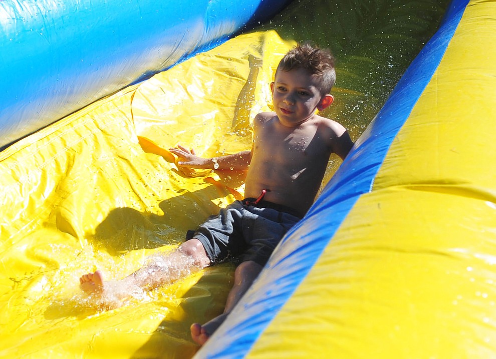 Tatum Podczerviensky, 6 of Prescott, enjoys a water slide at the City of Prescott's Watson Lake Fourth of July Celebration Thursday July 4, 2019. (Les Stukenberg/Courier)