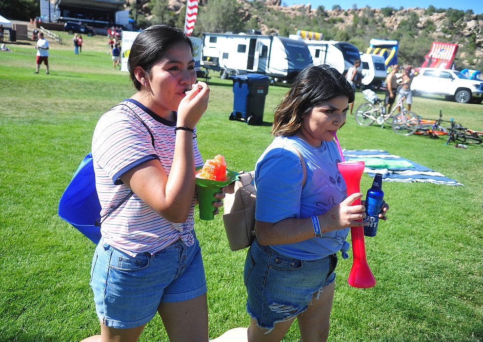 Angelica Castillo and Maria Reyes, both of Phoenix enjoy the frozen drinks at the City of Prescott's Watson Lake Fourth of July Celebration Thursday July 4, 2019. (Les Stukenberg/Courier)