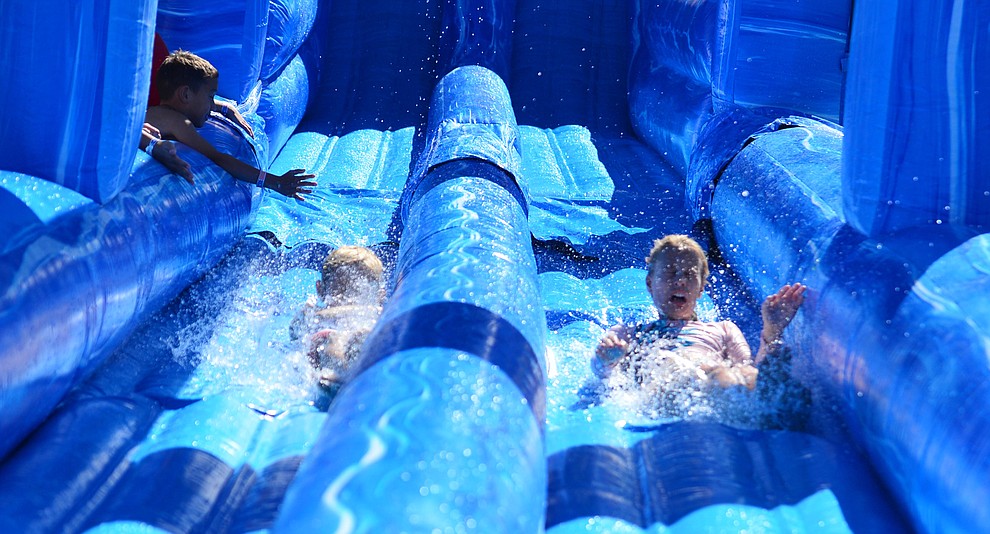 Kids enjoy the big water slides at the City of Prescott's Watson Lake Fourth of July Celebration Thursday July 4, 2019. (Les Stukenberg/Courier)