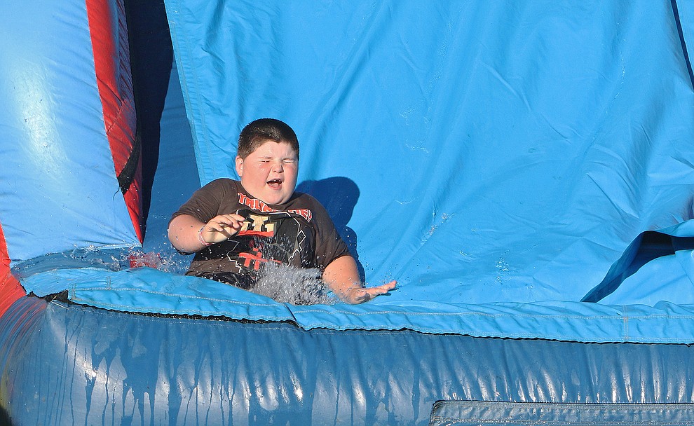 Edward Hunter (7 yrs old) of Chino Valley enjoys the splash down slide at the Chino Valley July 4th Celebration.