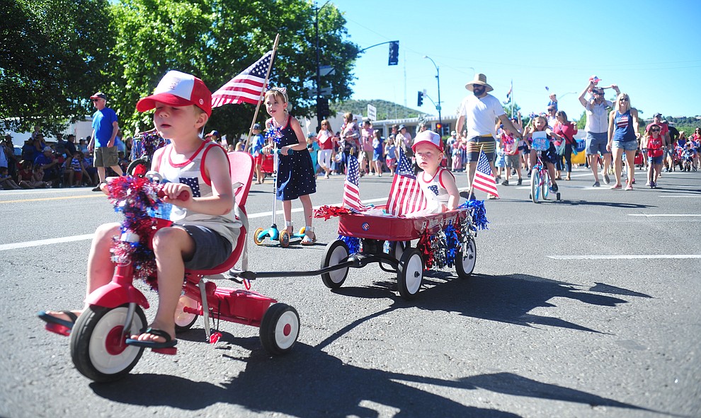 Children on bikes, scooters and in wagons ride during the 78th annual Kiwanis Kiddie Parade along Cortez Street in downtown Prescott Friday July 5, 2019. (Les Stukenberg/Courier)