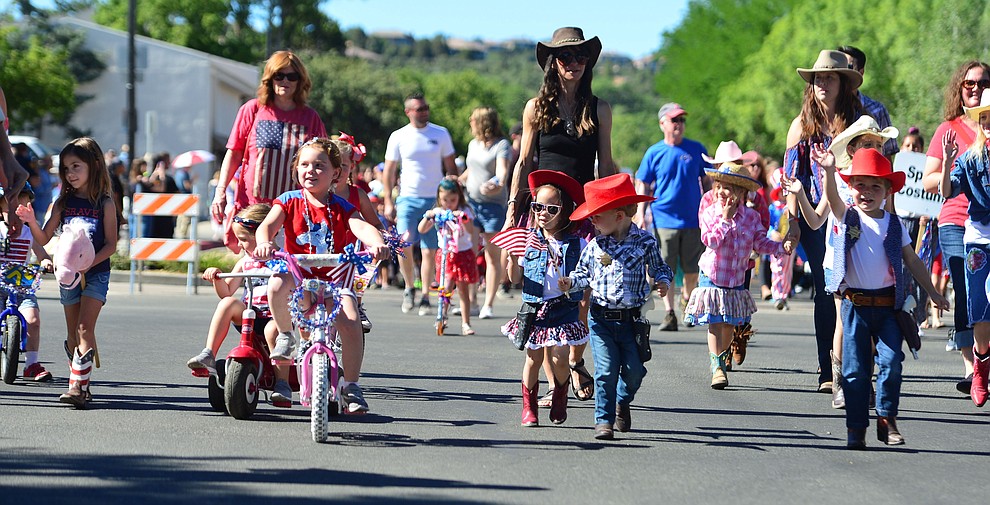 Children on bikes, scooters and in wagons ride during the 78th annual Kiwanis Kiddie Parade along Cortez Street in downtown Prescott Friday July 5, 2019. (Les Stukenberg/Courier)