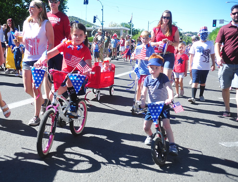 Children on bikes, scooters and in wagons ride during the 78th annual Kiwanis Kiddie Parade along Cortez Street in downtown Prescott Friday July 5, 2019. (Les Stukenberg/Courier)
