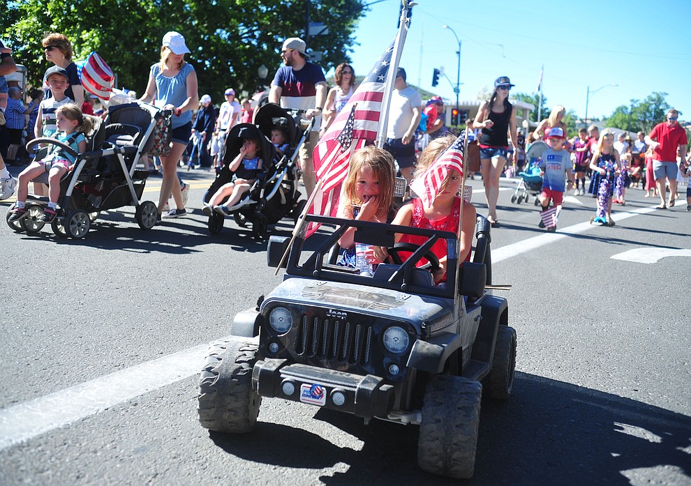 Children on bikes, scooters and in motorrized jeeps ride during the 78th annual Kiwanis Kiddie Parade along Cortez Street in downtown Prescott Friday July 5, 2019. (Les Stukenberg/Courier)