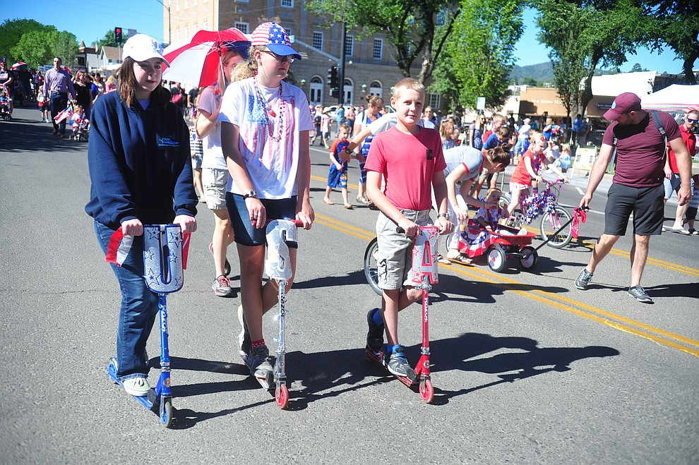 Children on bikes, scooters and in wagons ride during the 78th annual Kiwanis Kiddie Parade along Cortez Street in downtown Prescott Friday July 5, 2019. (Les Stukenberg/Courier)
