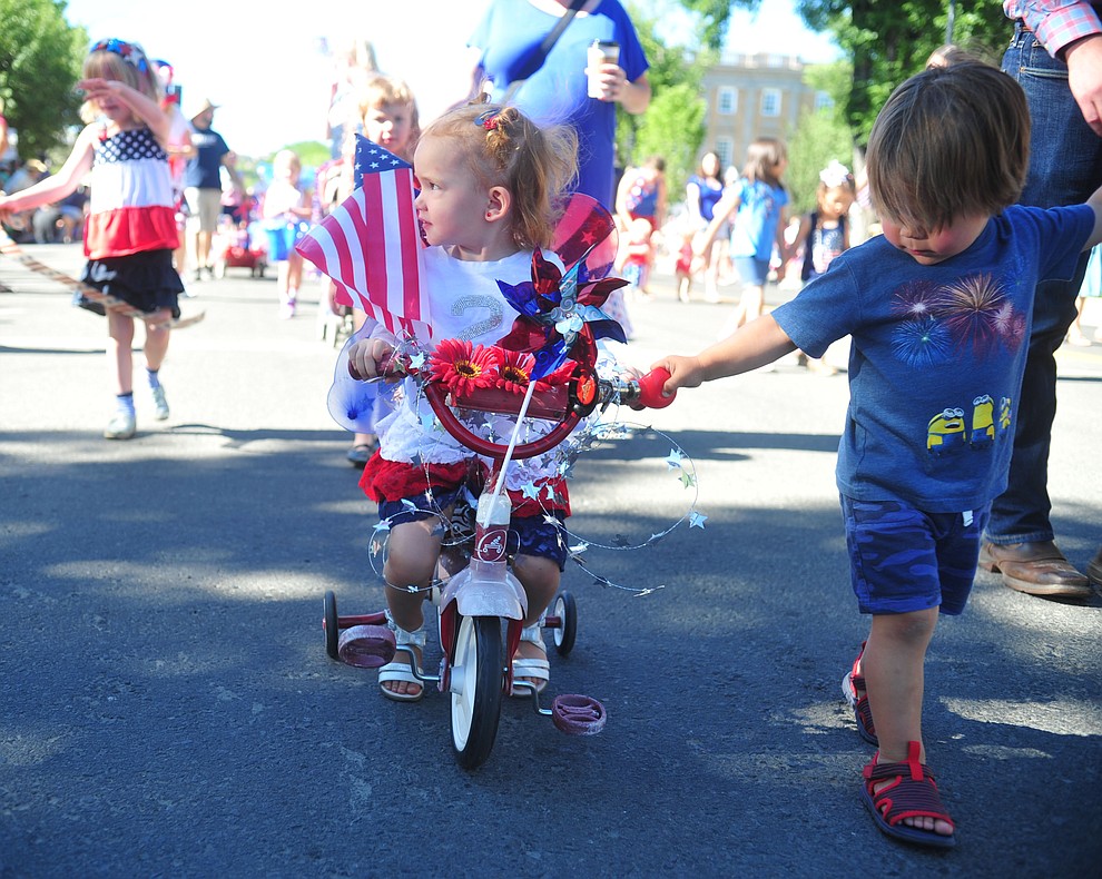 Children on bikes, scooters and in wagons ride during the 78th annual Kiwanis Kiddie Parade along Cortez Street in downtown Prescott Friday July 5, 2019. (Les Stukenberg/Courier)