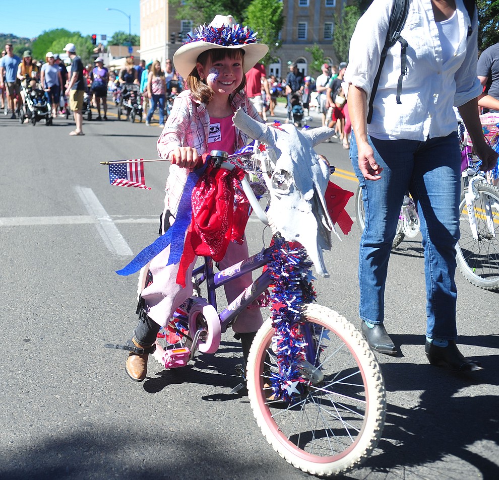 Ella Pifer rides her bike during the 78th annual Kiwanis Kiddie Parade along Cortez Street in downtown Prescott Friday July 5, 2019. (Les Stukenberg/Courier)