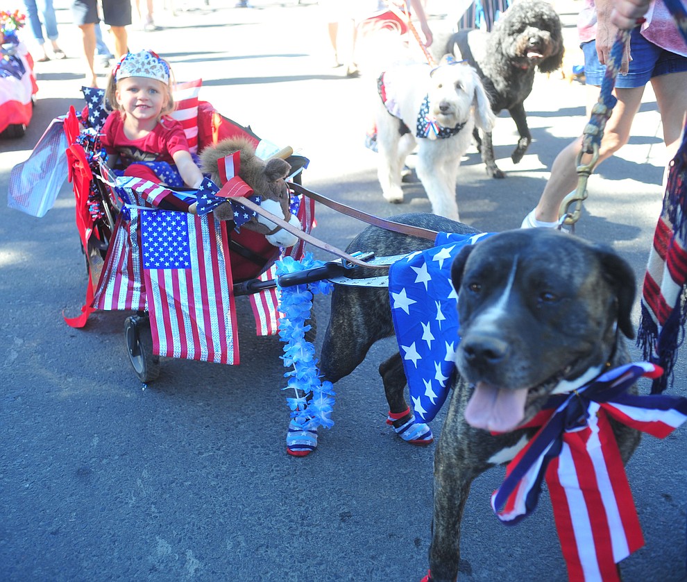 Tymbi Tompkins gets pulled down the street by Daisy during the 78th annual Kiwanis Kiddie Parade along Cortez Street in downtown Prescott Friday July 5, 2019. (Les Stukenberg/Courier)