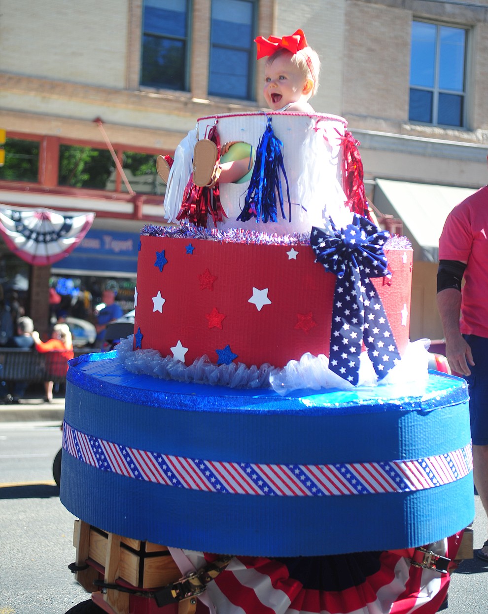 Ensley Smith is all smiles coming out of America's birthday cake during the 78th annual Kiwanis Kiddie Parade along Cortez Street in downtown Prescott Friday July 5, 2019. (Les Stukenberg/Courier)