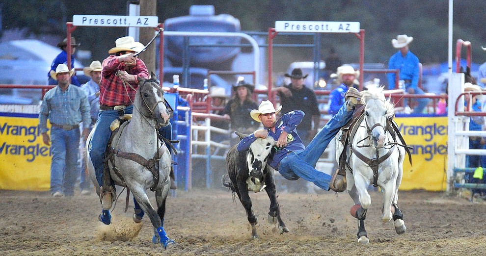 Blake Mindemann has a 4.6 second run in the steer wrestling during the 5th performance of the Prescott Frontier Days Rodeo at the Prescott Rodeo grounds Friday July 5, 2019. (Les Stukenberg/Courier)