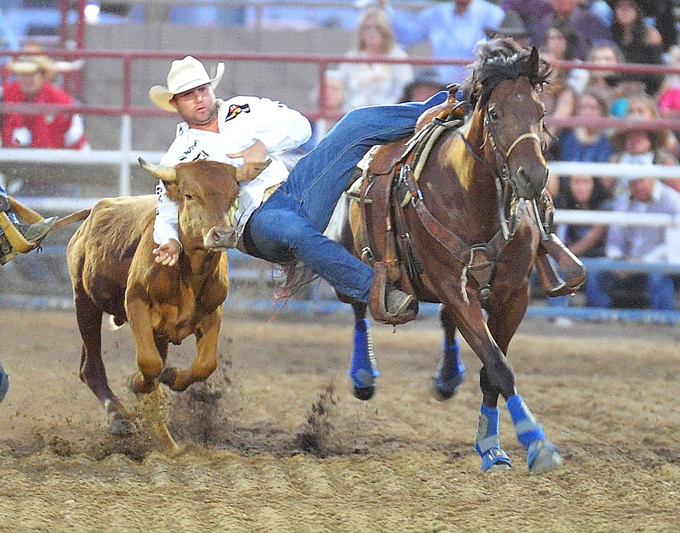 Tyler Waguespack drops in during the steer wrestling at the the 5th performance of the Prescott Frontier Days Rodeo Prescott Friday July 5, 2019. (Les Stukenberg/Courier)
