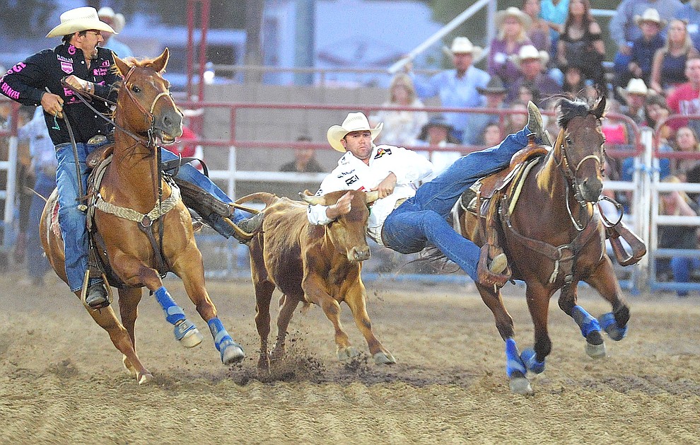 Tyler Waguespack drops in during the steer wrestling at the the 5th performance of the Prescott Frontier Days Rodeo Prescott Friday July 5, 2019. (Les Stukenberg/Courier)